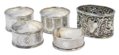 A group of Victorian and later silver napkin rings, to include a napkin ring, repousse decorated...