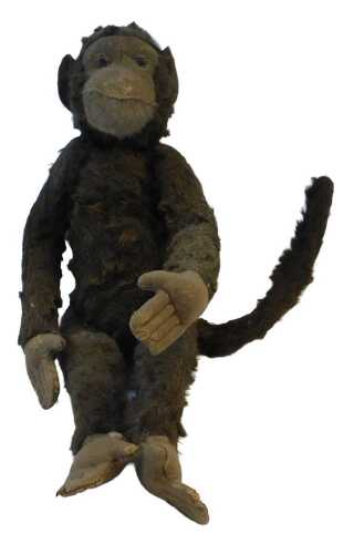 An early 20thC Steiff monkey, with felt pads, 39cm high. (AF)