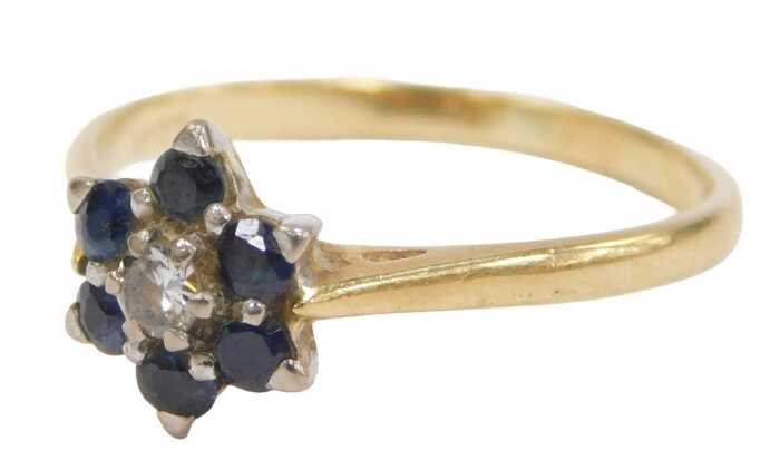 A sapphire and diamond floral cluster ring, the round brilliant cut diamond surrounded by six...