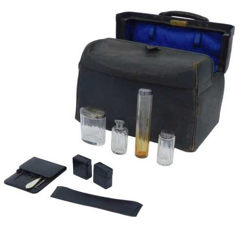 A late Victorian black leather Gladstone style travelling case, the blue satin interior...