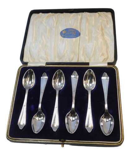 A set of six George V silver coffee spoons, each handle decorated with a rosette, cased,...