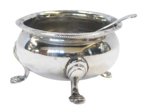 A George V silver open salt, of cauldron form, raised on three pad feet, Chester 1918, together...