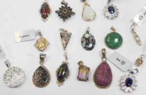 A quantity of pendants, to include silver stone and floral clusters, rough cut, agate, and... - 2