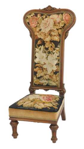 A Victorian mahogany prie dieu chair, the shaped moulded showframe back inset with a floral...