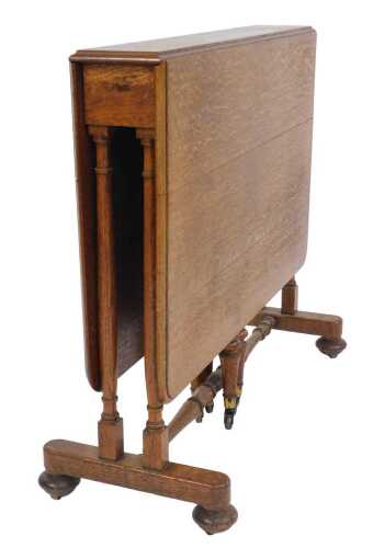A Victorian oak Sutherland table, the top with a rounded edge, raised on turned supports, on...