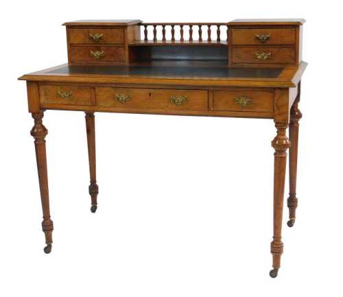 A Victorian walnut desk, the top with a raised back with two drawers to each side, united by a...