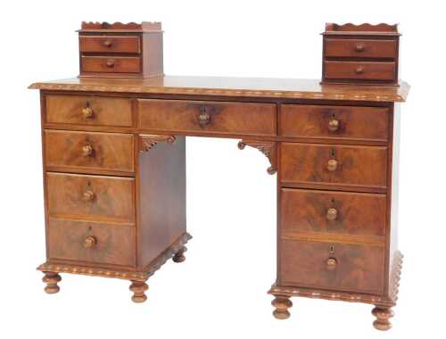 A 19thC Continental mahogany desk, the top with a two drawer section to each side with a raised...