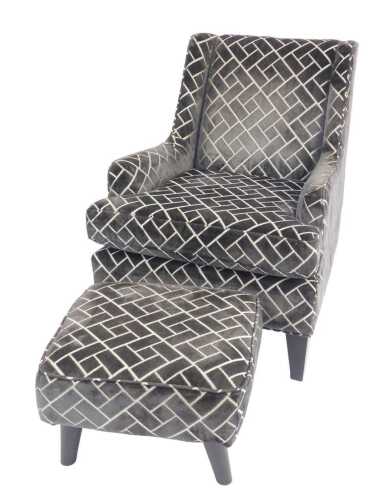 A contemporary armchair and footstool, each upholstered in geometric grey fabric.