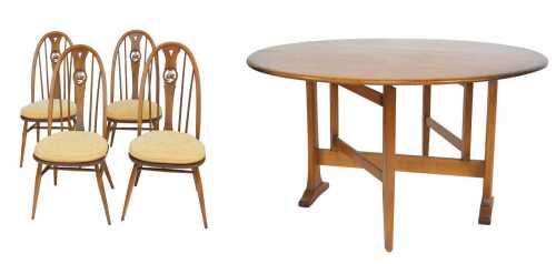 An Ercol elm drop leaf table, the circular top raised on outsplayed legs, bearing label, 71cm...