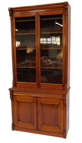 A Victorian mahogany bookcase cabinet, the top with a moulded edge above two glass fronted doors...