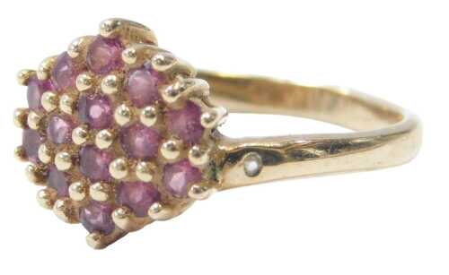 A 9ct gold and pink topaz dress ring, the ring head pave design set with pink topaz, each claw...