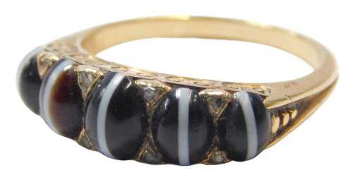 An Edwardian banded agate ring, set with five oval cabochon agates and eight tiny diamonds, in a...