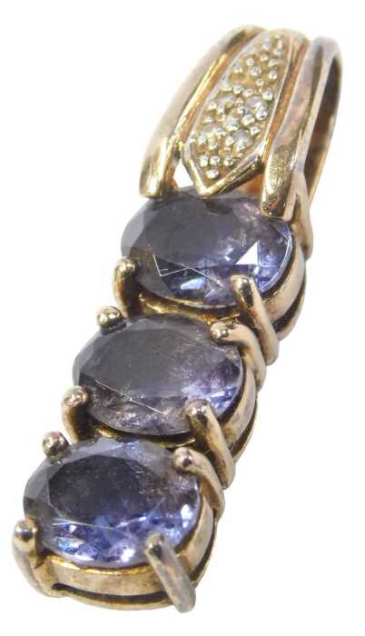 A 9ct gold pendant, the top set with tiny diamonds, with a three oval cut amethyst drop, 3cm...
