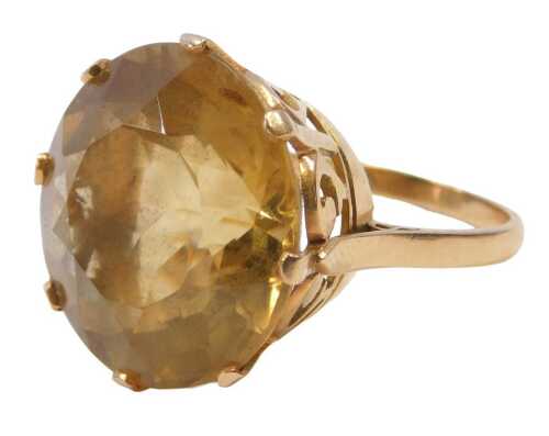 A citrine single stone dress ring, the round brilliant cut citrine, 18.6mm x 11mm, in an eight...