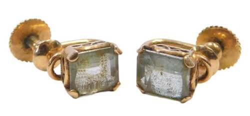 A pair of early 20thC aquamarine screw-back earrings, each set with a square-cut aquamarine, in...