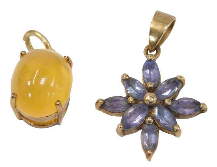 Two 9ct gold pendants, comprising a tanzanite star set pendant, 2.5cm high, and a cabochon...
