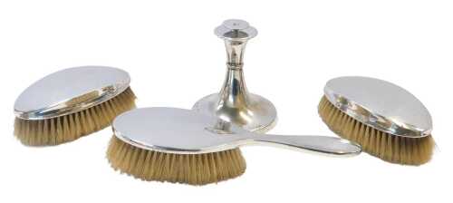 A George VI three-piece silver-mounted dressing table set, comprising two clothes brushes and...