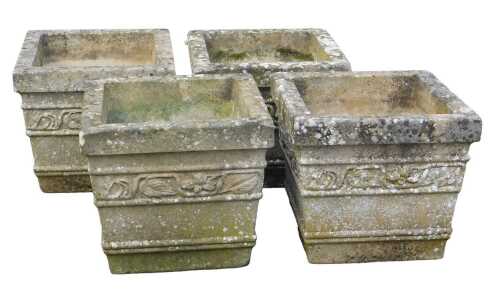 Four composition stone garden planters, each of square form, decorated with a band of leaves,...
