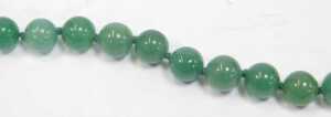 A jade single strand necklace, with carved spherical beads, on a knotted string strand, 66cm... - 2
