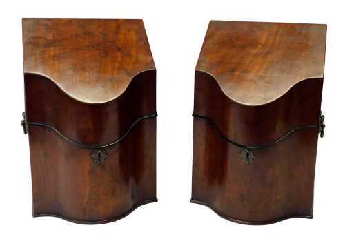 A pair of George III mahogany knife boxes, each of serpentine form, the hinged lid opening to...