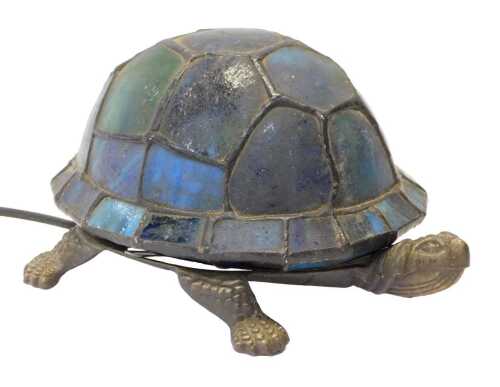 A Tiffany style tortoise table lamp, the shell in shades of blue and green glass, on a cast...