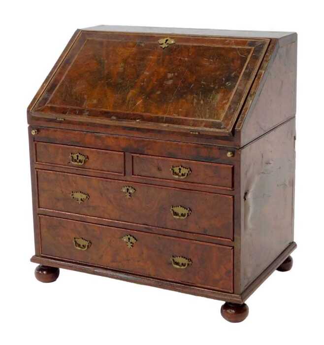 A 19thC walnut tea caddy modelled as a bureau, the hinged lid opening to reveal lidded twin...