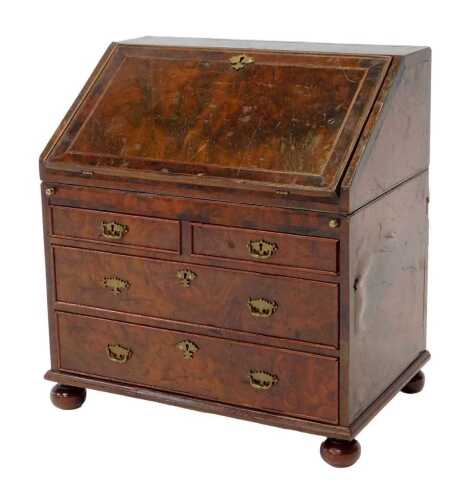 A 19thC walnut tea caddy modelled as a bureau, the hinged lid opening to reveal lidded twin...