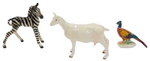 A West German figure of a zebra, printed marks, 14cm high, together with a Beswick pheasant, and...