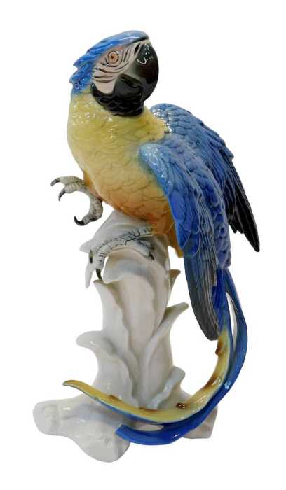 A Karl Ens porcelain figure modelled as a parrot, in a blue and yellow colourway, mounted on a...