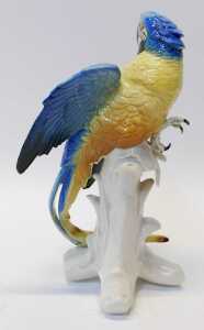 A Karl Ens porcelain figure modelled as a parrot, in a blue and yellow colourway, mounted on a... - 2