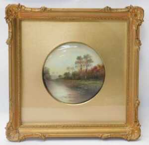 A Paragon porcelain plaque, painted with a river landscape, by F Micklewright, 12cm diameter, in... - 2