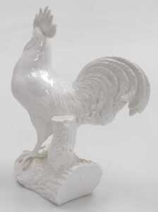 A Royal Crown Derby blanc-de-chine porcelain figure of a cockerel, modelled perched on a log,... - 2