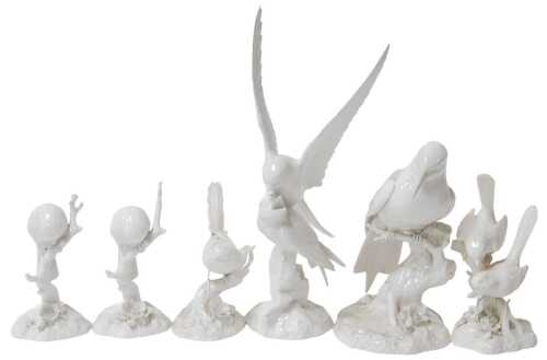 Six Royal Crown Derby blanc-de-chine porcelain figures of birds, including a gull feeding its...