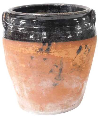 A 19thC terracotta and black-glazed twin-handled crockpot, 35cm high.