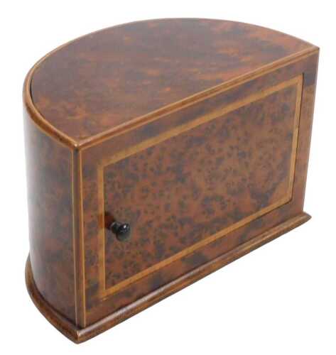 An early 20thC burr wood demi-lune cigarette box, with satinwood crossbanding, the hinged door...