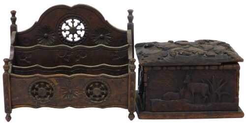 A late 19thC Breton carved wooden stationery rack, of waterfall form, decorated with a wheel and...