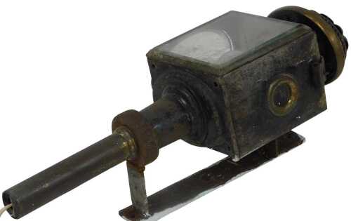 A Victorian tin carriage lantern, with a cast iron mounting bracket, 48cm high.