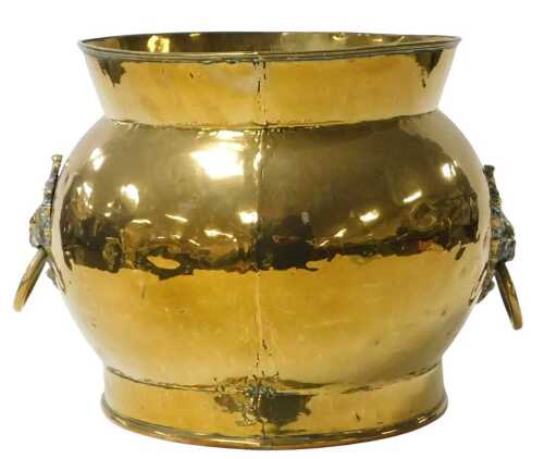 A brass coal bucket, of circular form, with twin lion's head and ring handles, 36cm wide.