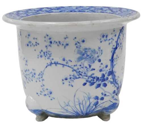 An early 20thC Japanese blue and white porcelain jardiniere, decorated with flowers and blossom,...