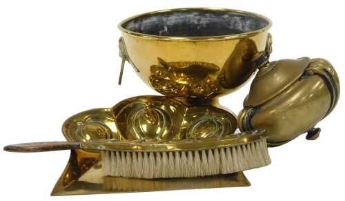 An early 20thC Art Nouveau brass crumb scoop, and brush with a wooden handle, together with an...