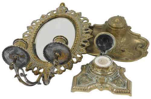 A late 19thC brass girandole, with an oval bevelled glass mirror, in a cast floral pierced frame,...
