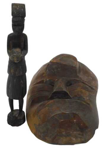 A 20thC African tribal mask, carved with a protruding forehead and downturned mouth, 43cm high,...