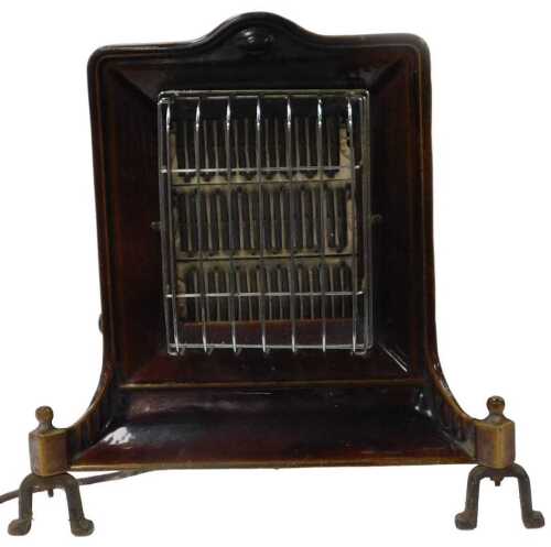 An early 20thC Arora Company brown enamel and tin electric heater, 49cm high, 51cm wide.