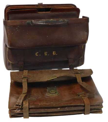 An early 20thC brown leather travelling case, gilt monogrammed, opening to reveal a brown...