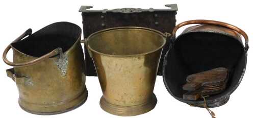 A Victorian copper coal scuttle, a brass coal scuttle, a brass coal bucket, a pair of fire...