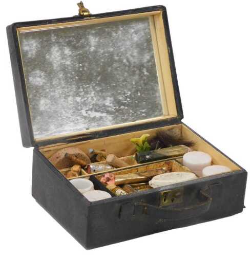 An early 20thC black leather bound jewellery box, containing artist's paints and other materials,...