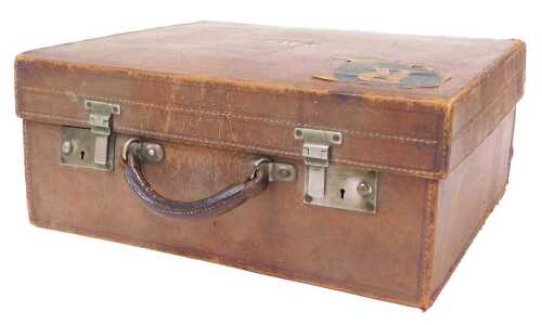 An early 20thC tan leather travelling case, with a brown mottled silk interior, bears traces of...