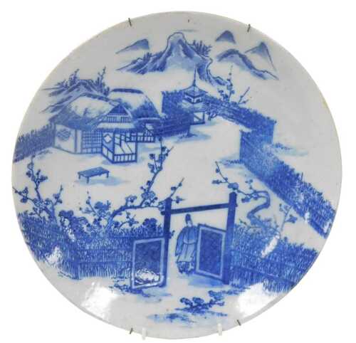 A Japanese Meiji period Arita blue and white porcelain charger, decorated with a figure at the...