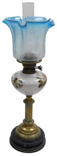 A late 19thC duplex brass oil lamp, with a milk glass reservoir over painted with flowers, glass...