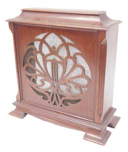 An early 20thC Celestial mahogany radio casing, with a fabric backed fret work front panel,...